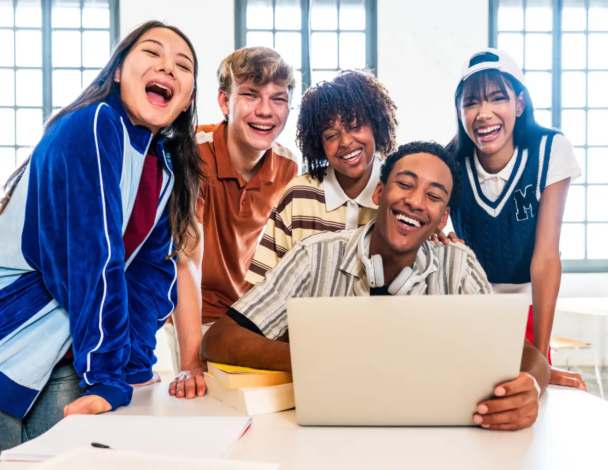 Jonge mensen lachend achter een laptop