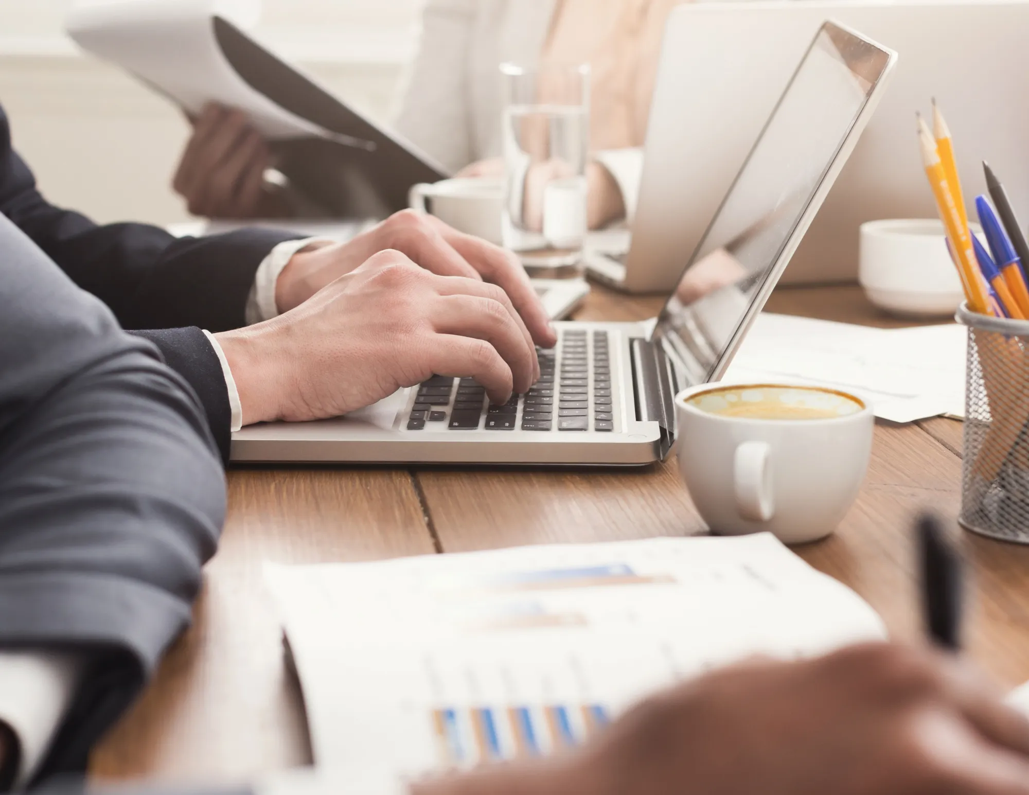 Man typt achter laptop aan het werk